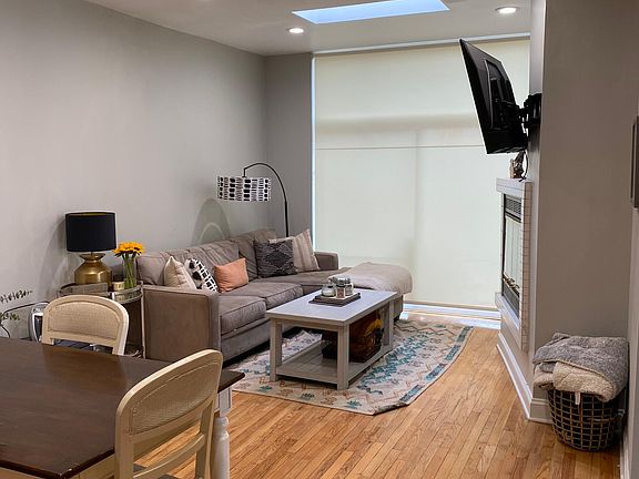 Family room with modern ceiling fan and skylight