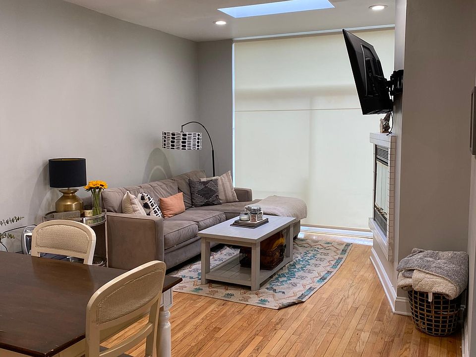 Family room with modern ceiling fan and skylight