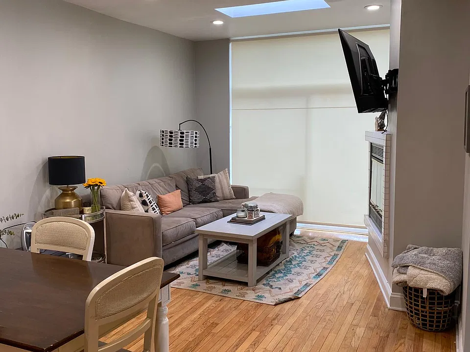 Family room with modern ceiling fan and skylight