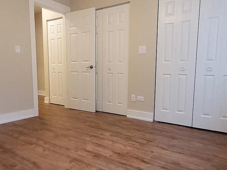 Large primary bedroom with full wall of closets.