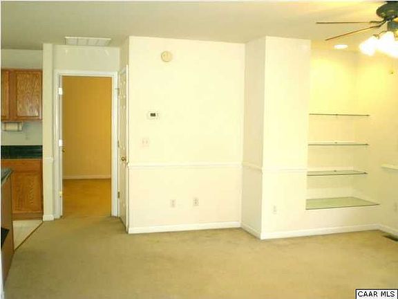 Living room, built in glass shelves, master bedroom beyond