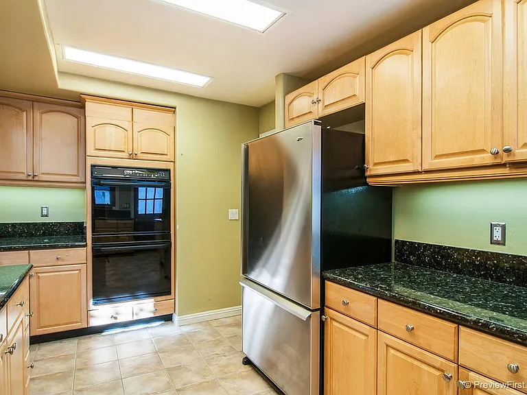 Stainless steel refrigerator, 
Kitchen now has an electric stainless steel range and oven in addition to the gas stovetop.
