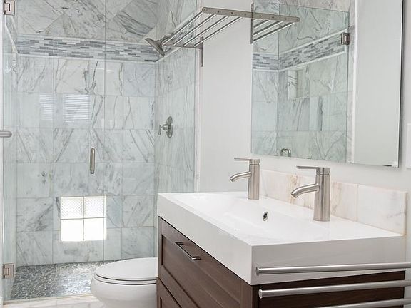 All marble floor and shower tile to the ceiling. Deep drawers for storage of personal bathroom items. Plenty of room for hairdryers, make-up and more.