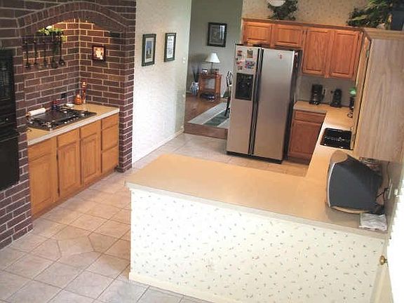 Large Kitchen with custom tile and brick hearth
