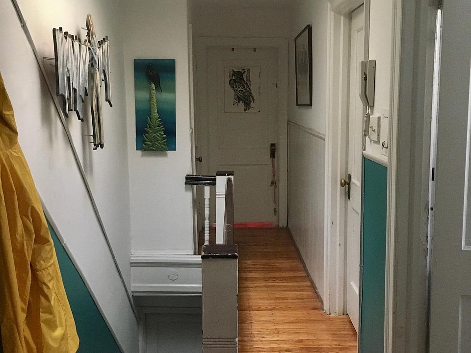 Hallway closet on the left beyond the stairs.