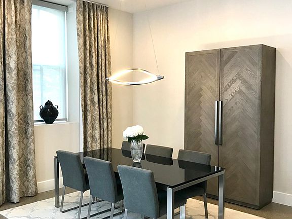 Spacious dining area with natural light and modern light fixture