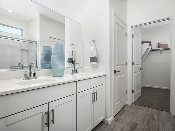The primary bathroom features a walk-in closet, walk-in shower and linen closet.