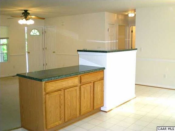 Kitchen island, back of fireplace and living room