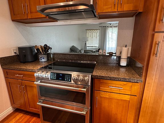 New high end Cafe_ 30" Smart Slide-In, Front-Control, Induction and Convection Double-Oven Range! Top tier selection - google the range if you have time. This picture allows you to see into the living room.