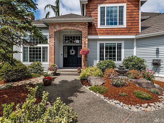 Beautiful landscaping, wood siding, 50 year roof - this home can be yours!