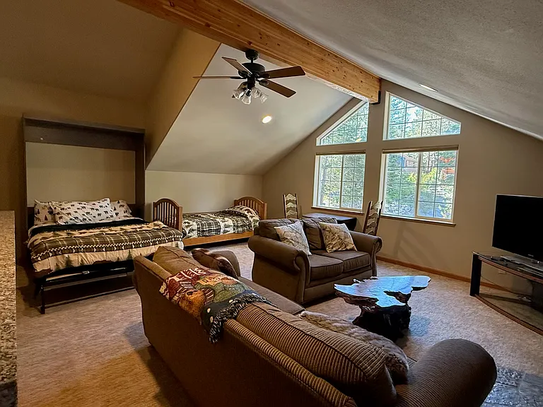 Huge game room with queen murphy bed, twin bed two couches, and wet bar