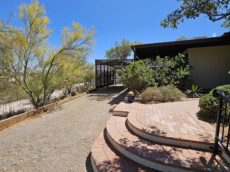 Driveway with covered carport. There's an electrical outlet for EV charging.