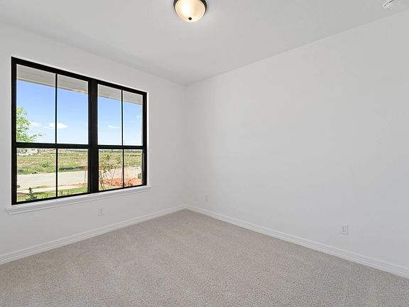 The fifth bedroom perfect for an in law suite features plush carpet, fresh paint, closet, and a larg