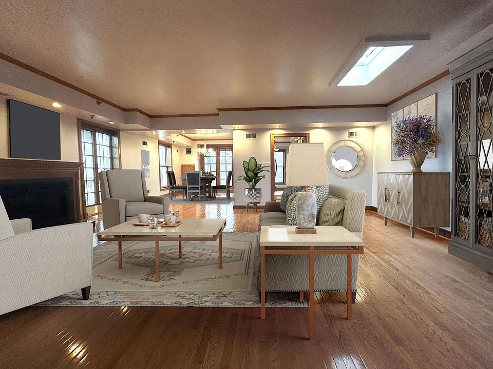 Massive Living Room w/ skylight, beautiful hardwood floors throughout