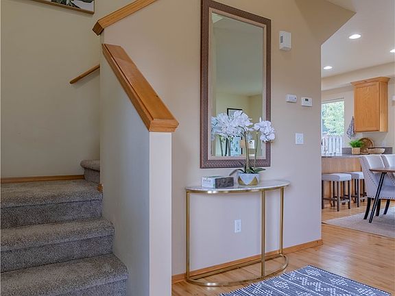 Entry with Vaulted ceiling showing the main floor hard woods and open Floor plan. The Main floor den is just to the right of the Entry. 