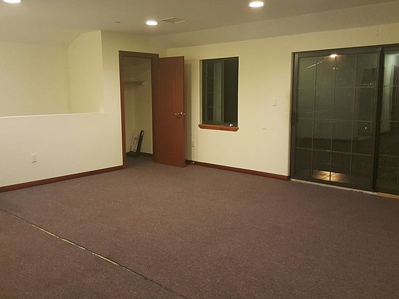 small closet in living room with balcony