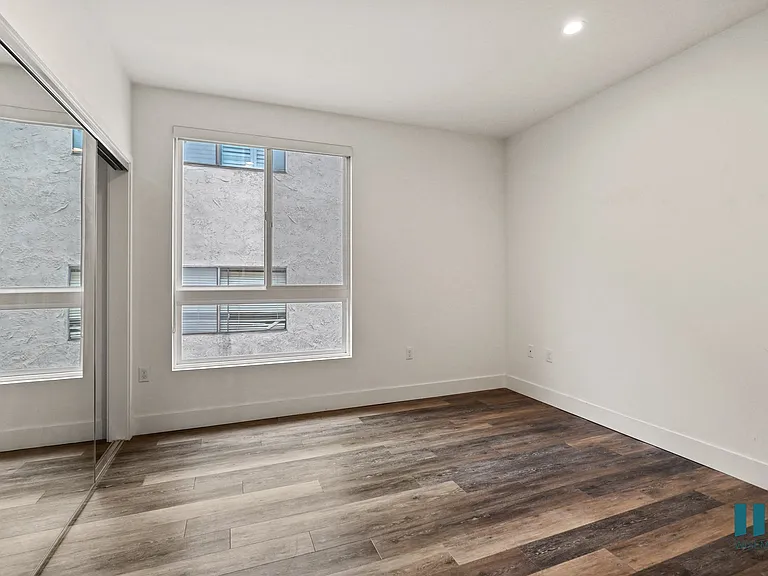 Bedroom Vinyl Flooring, Large-Size Windows, and Recessed Lighting