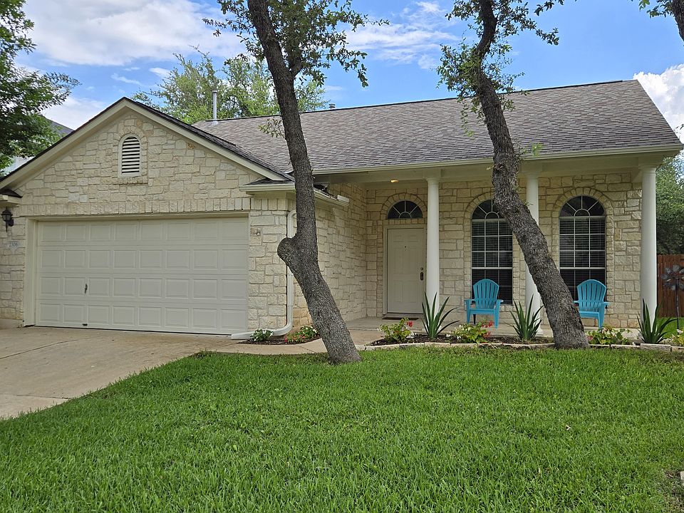 Front of house, large lawn, patio, 2 car garage