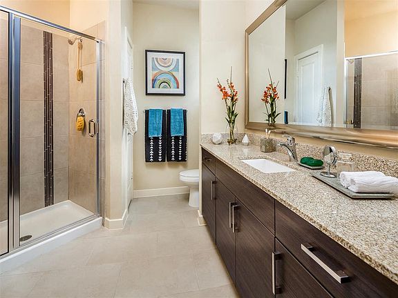 Master bathroom with access to walk-in closet, double vanity and standing shower