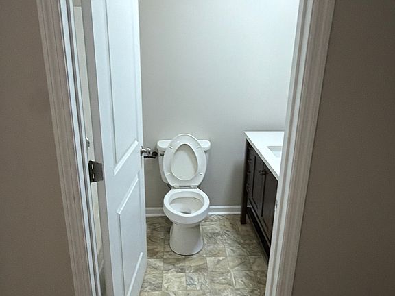 Private primary bathroom with a modern vanity and easy-care flooring.