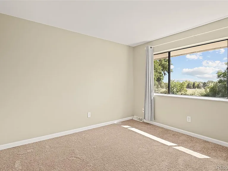 Upstairs bedroom. Lots of natural light, overlooking walking path and well-maintained green belt.