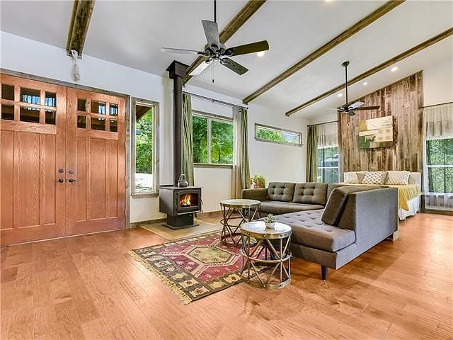 High Vaulted Ceilings, charming free standing fireplace, ceilings fans, lots of windows with shaded natural light