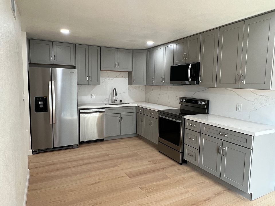 Kitchen with new cabinets, quarts countertop and back splash and new appliances.
