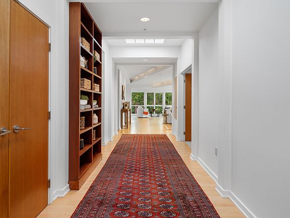 A dramatic entry sets the tone, flanked by custom built-in bookcases complimented by an oversized coat closet.