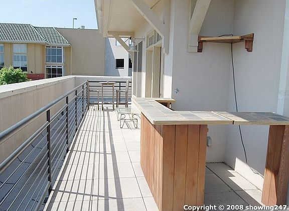 The private rooftop terrace features speakers and custom built bar.