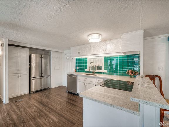 Quartz counters, new cabinets, stainless KitchenAide appliances, new vinyl plank flooring!