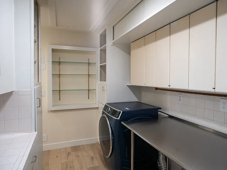 Here you can see the sheer amount of storage this area contains including those beautiful display cases against the far wall with glass shelves.