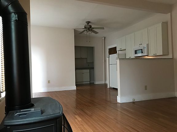 toward kitchen and apartment entry from antique look fireplace stove