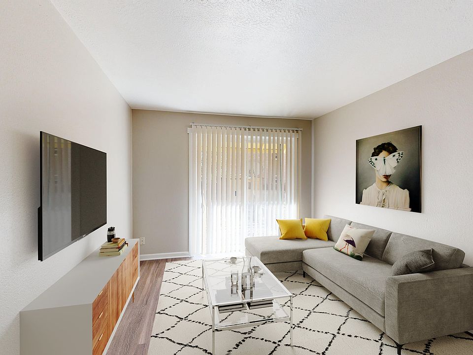 Chic living room with contemporary decor, featuring a plush gray sofa, vibrant yellow accents, and a stylish wall art centerpiece.