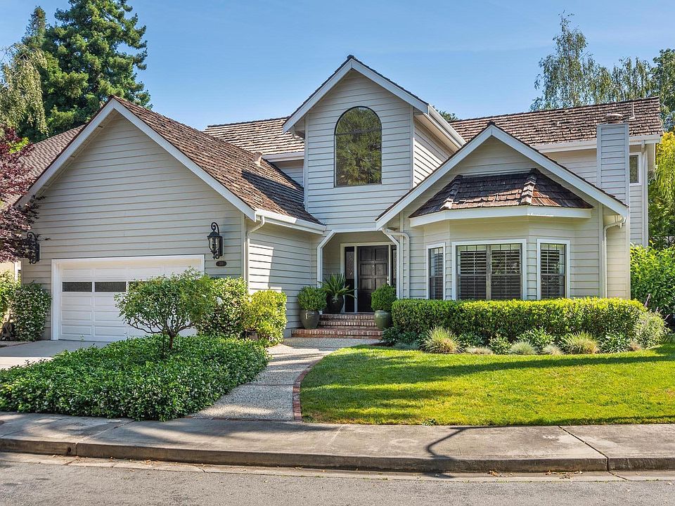 Lush front yard with mature landscaping (roses, peonies, hedges and lawn)