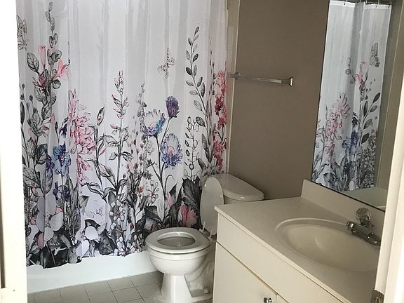 Master bath with closet behind door
