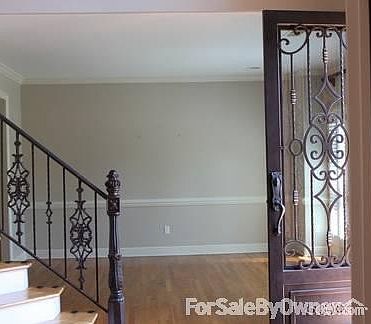 Grand two story entry
						:
						Oversized, custom iron doors lead inside the elegant 2 story entrance.