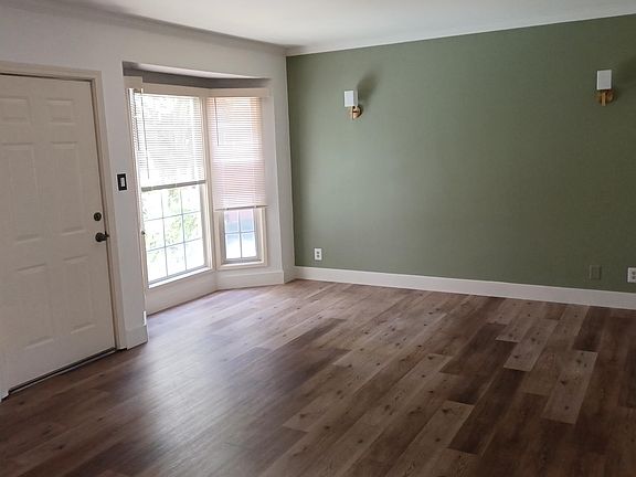 Living Room offers view to garden thru bay window.