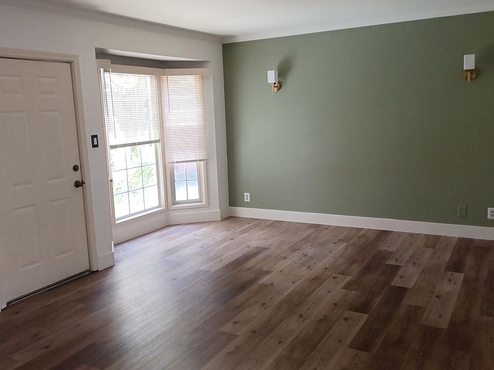 Living Room offers view to garden thru bay window.
