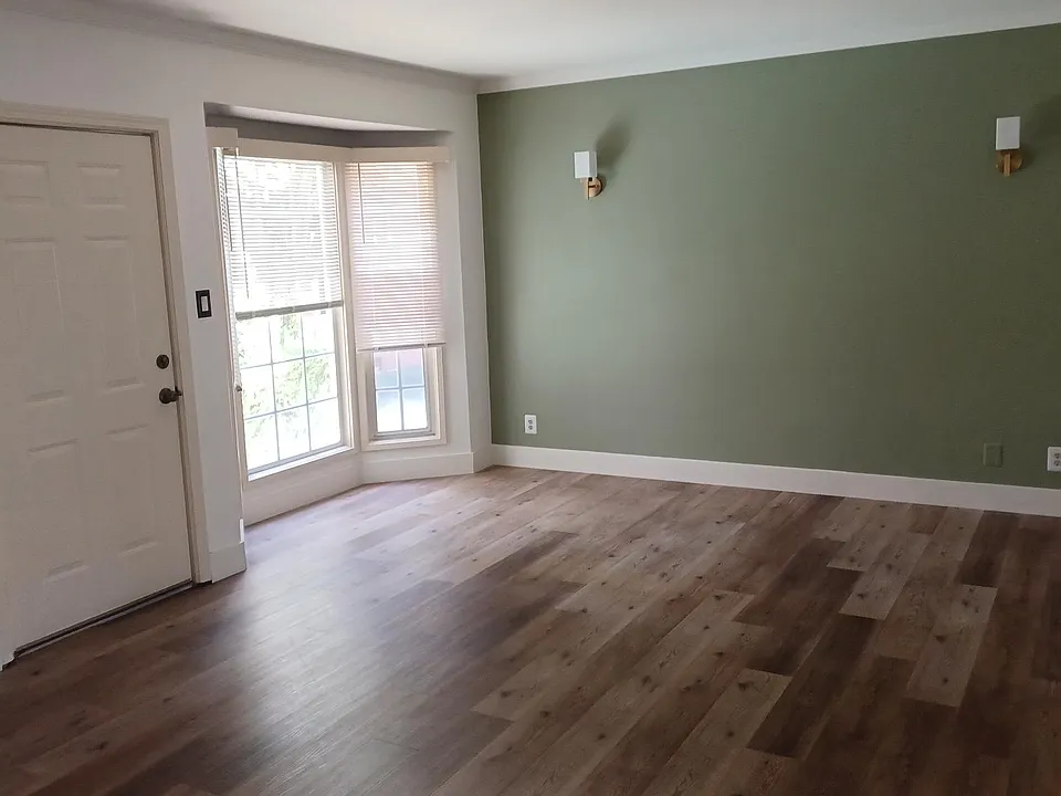 Living Room offers view to garden thru bay window.
