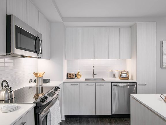 Contemporary kitchens include glass tile backsplash, premium quartz countertops, and designer lighting