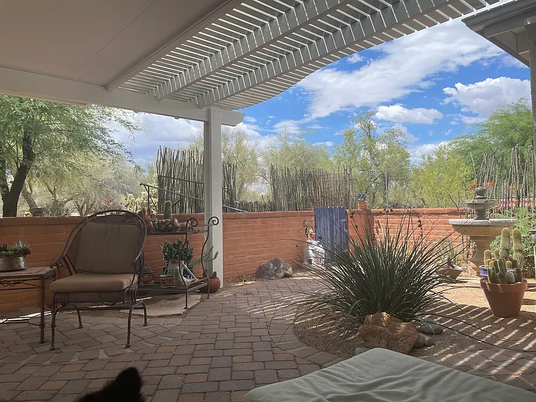 The space feels private with a view of the pedestrian walkway and undeveloped desert.