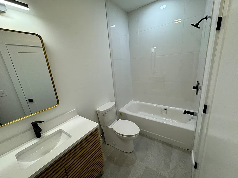 Common bath toilet and tiled shower.