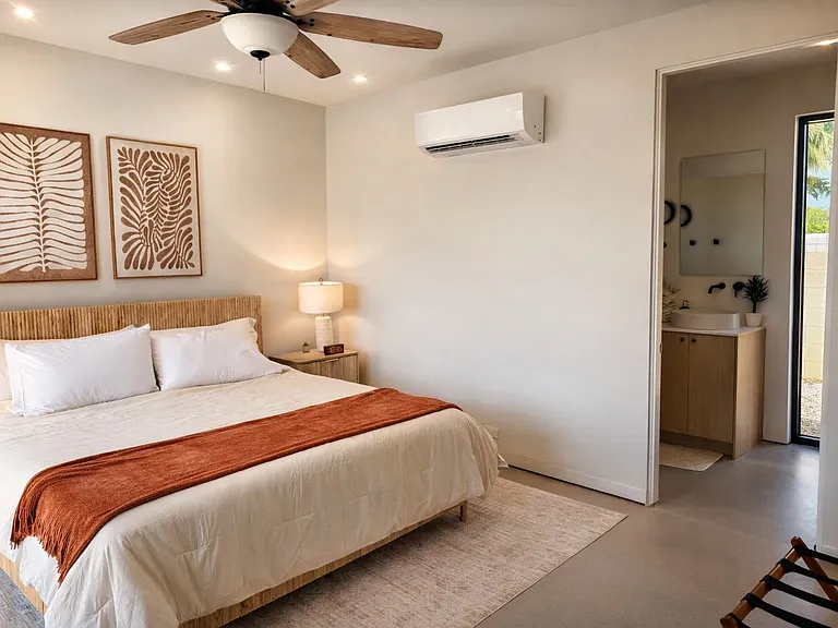 Bright and serene primary bedroom featuring a king bed, warm wood accents, and a ceiling fan for added comfort.