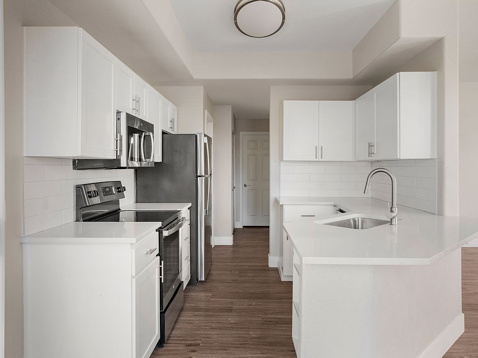Kitchen area that leads to a spacious balcony with its own storage close