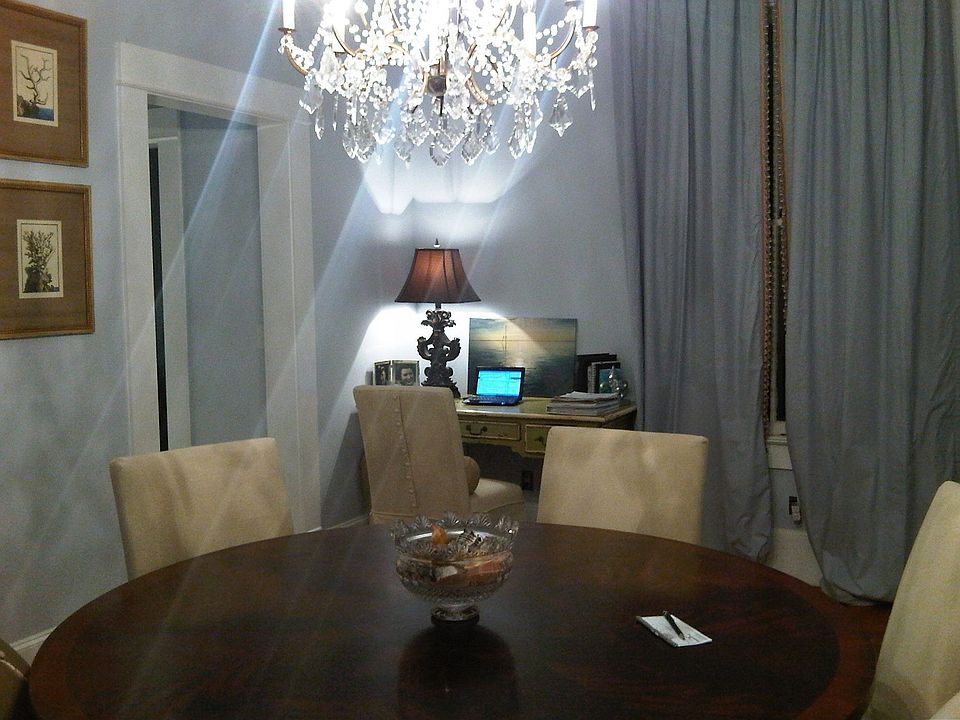 dining w/custon curtains and crystal chandlier