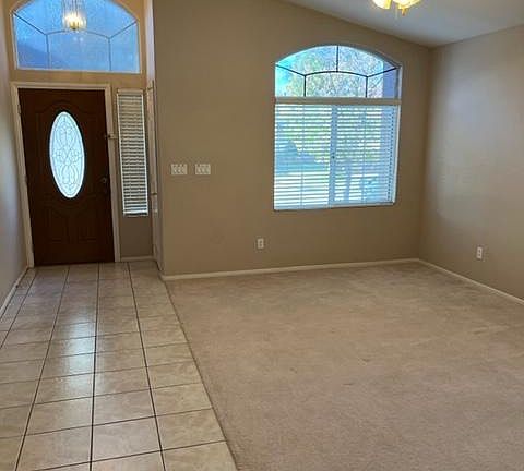 Entry and carpeted living room