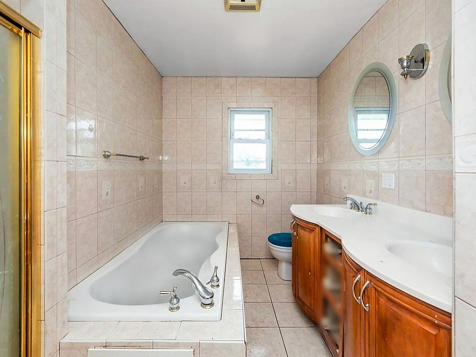 Bathroom with Jacuzzi and stand-up shower.