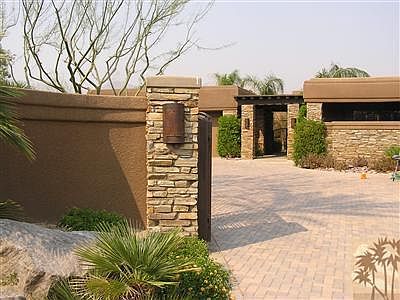 From the moment you enter this estate property you notice the attention to detail. Decorative paver driveway with automatic gates and custom stone pillars. Three car garage (or two car plus two cart). The garage