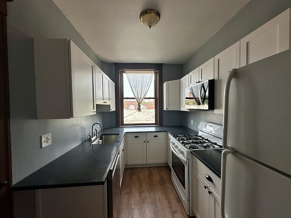 New Kitchen with Quartz countertops, dishwasher, disposal, stove and refrigerator