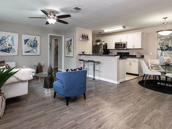 Revel in the airy openness of our floor plans with unblocked views across living spaces accentuated by sleek wood-style flooring.